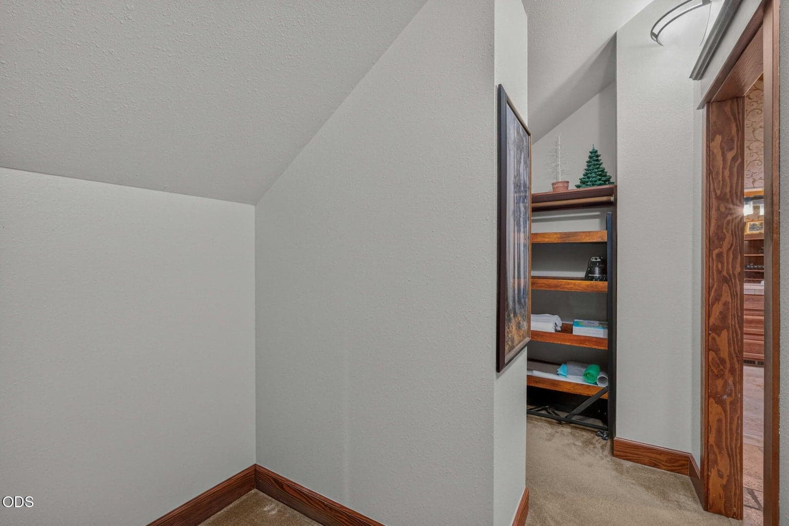 Another view of built-in shelving and angled ceiling features as you look back towards the bathroom.