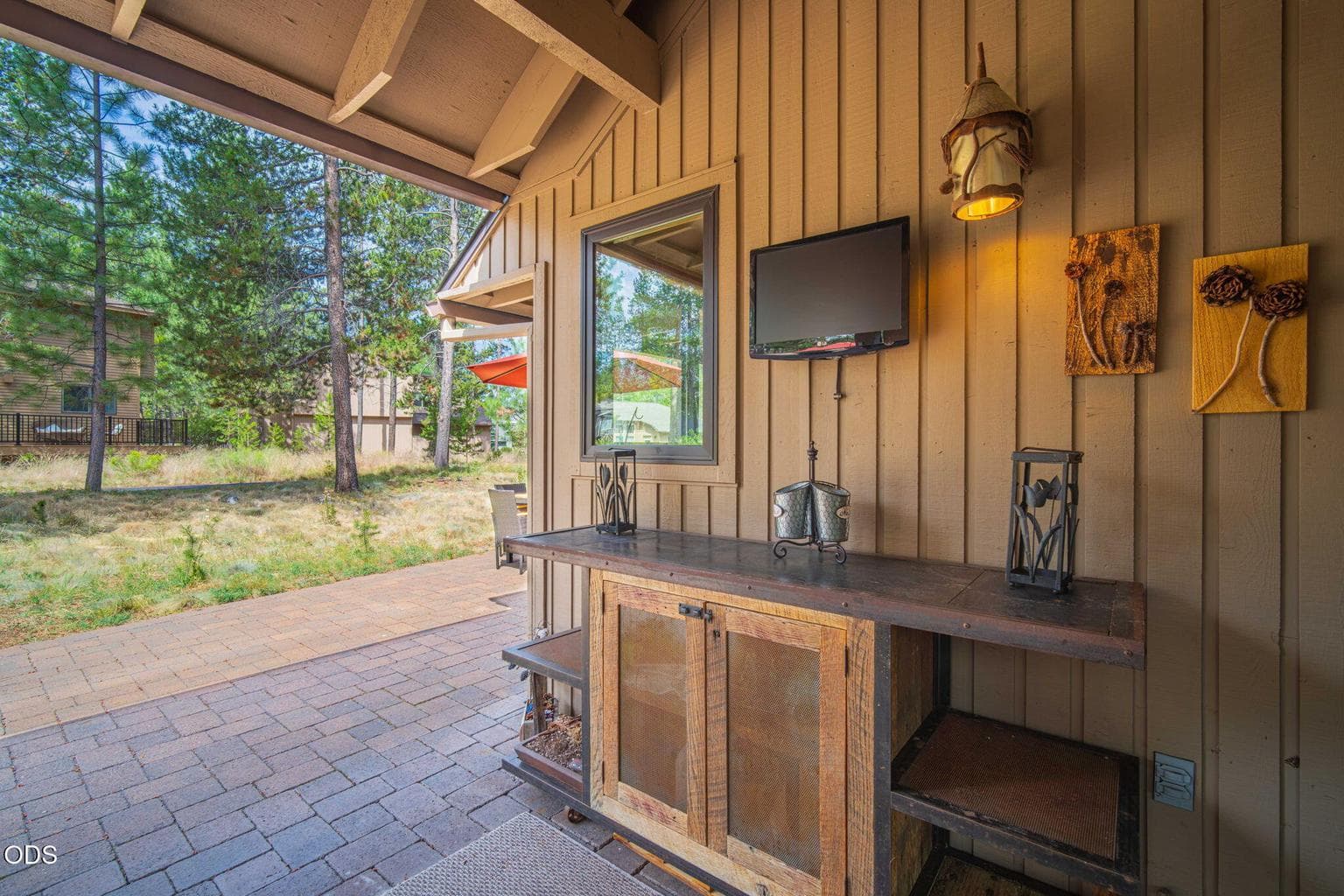 Covered patio area extending to paver patio facilitates year round outdoor lounging or dining - wired for a tv if you like.