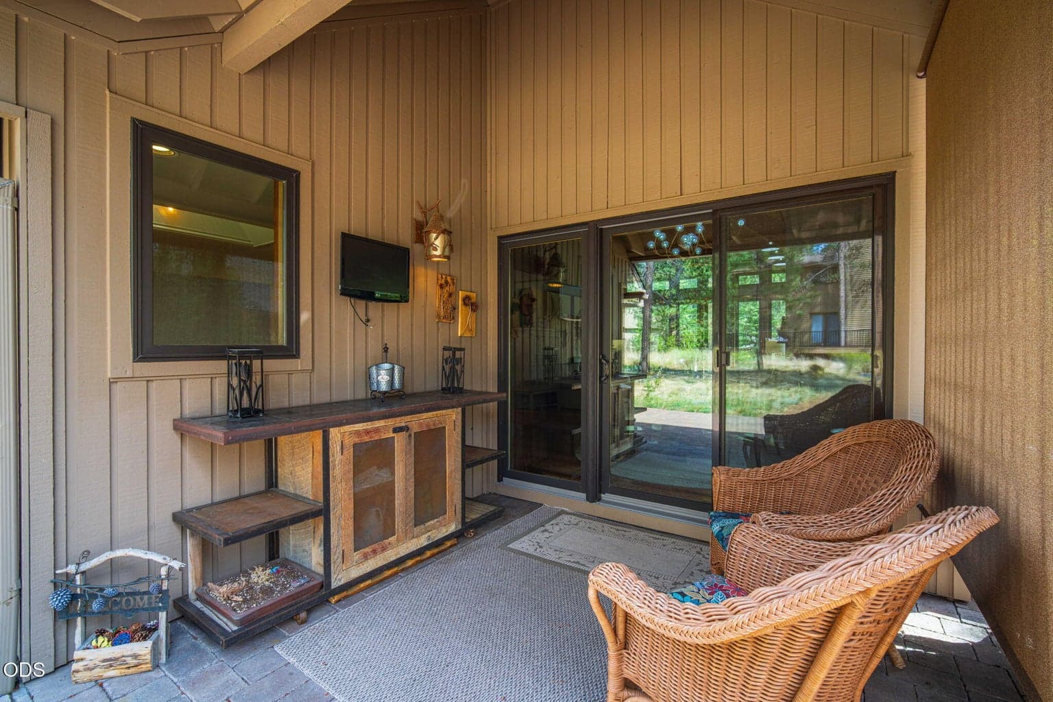 Sheltered back patio offering seamless indoor/outdoor connection to nature and fresh air.
