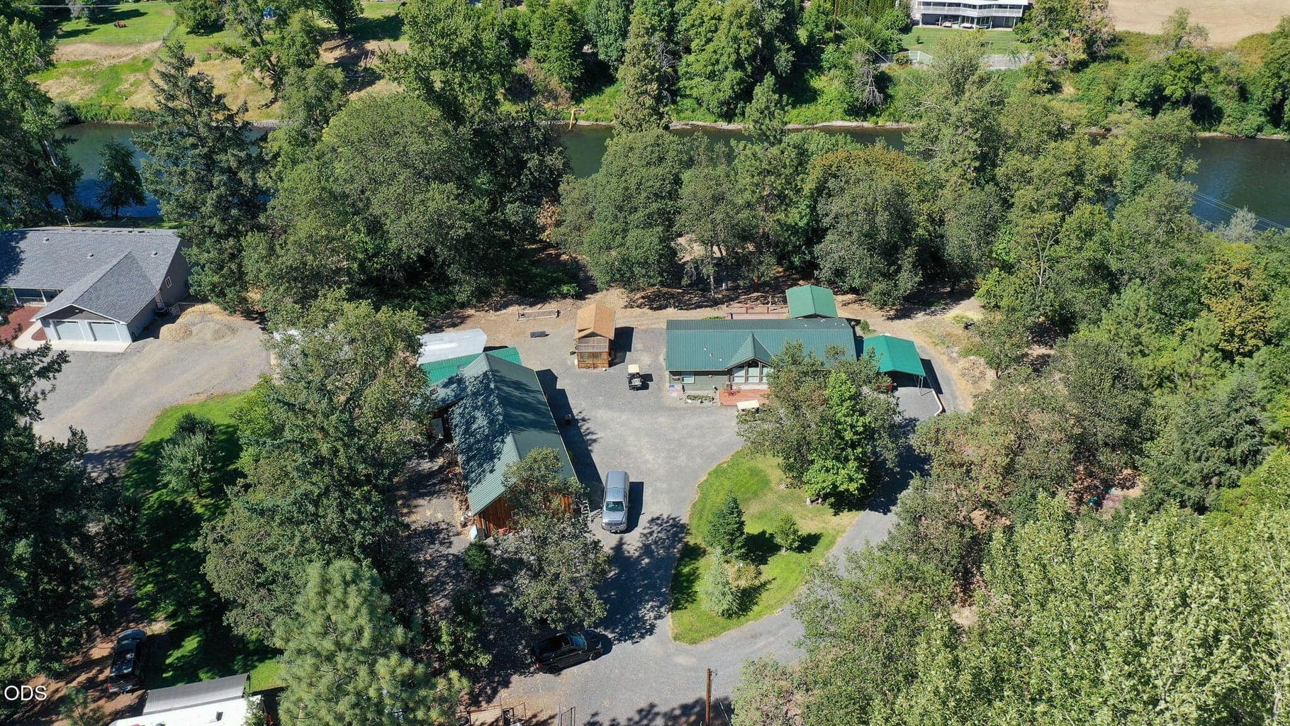 Wonderful set up! Home, 4 bay garage w/ bathroom, RV parking/hook up, Artist studio and over 325 ft of Rogue River frontage.