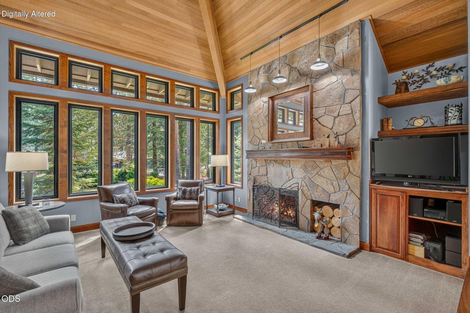 Expansive windows frame forest views and fill the living room with natural light.