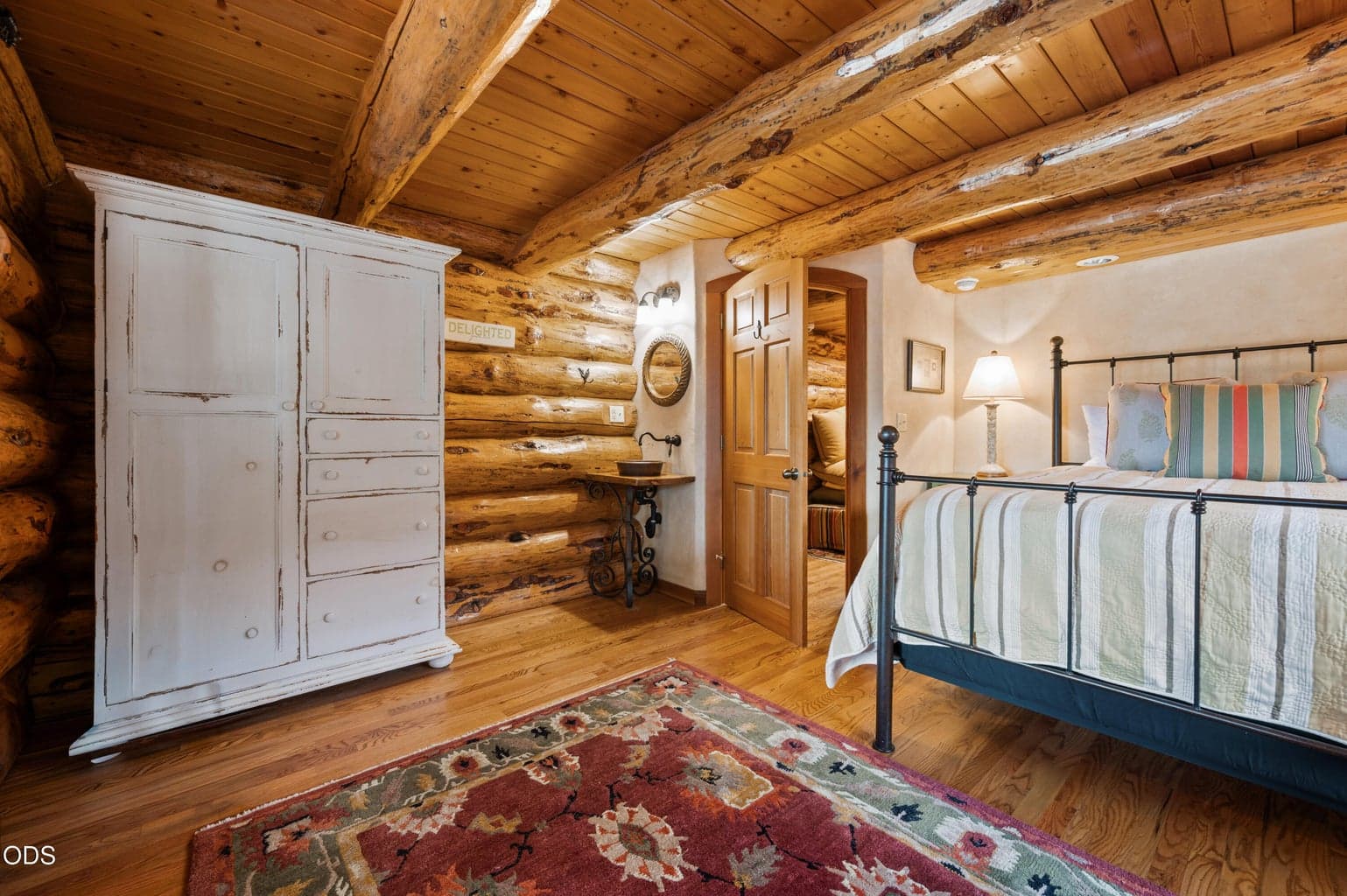 Located on the main level, this bedroom features a charming window seat and guest vanity.