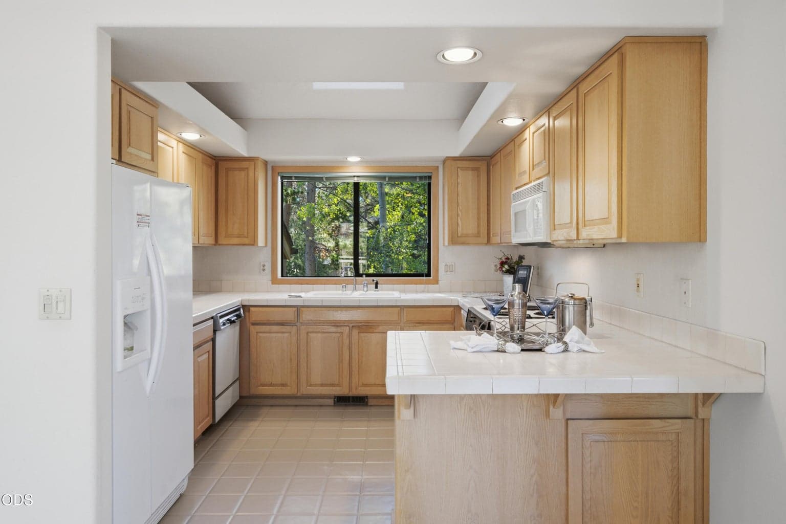 Great views to the front and backyard's treed landscaping so you feel like you're on vacation if you're working in the kitchen!