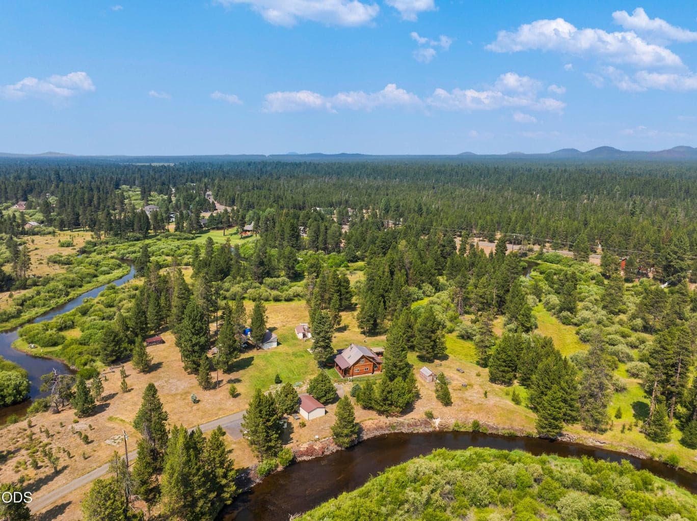 NW CUSTOM LOG HOME ON 22+ ACRES SURROUNDED BY THE LITTLE DESCHUTES RIVER!