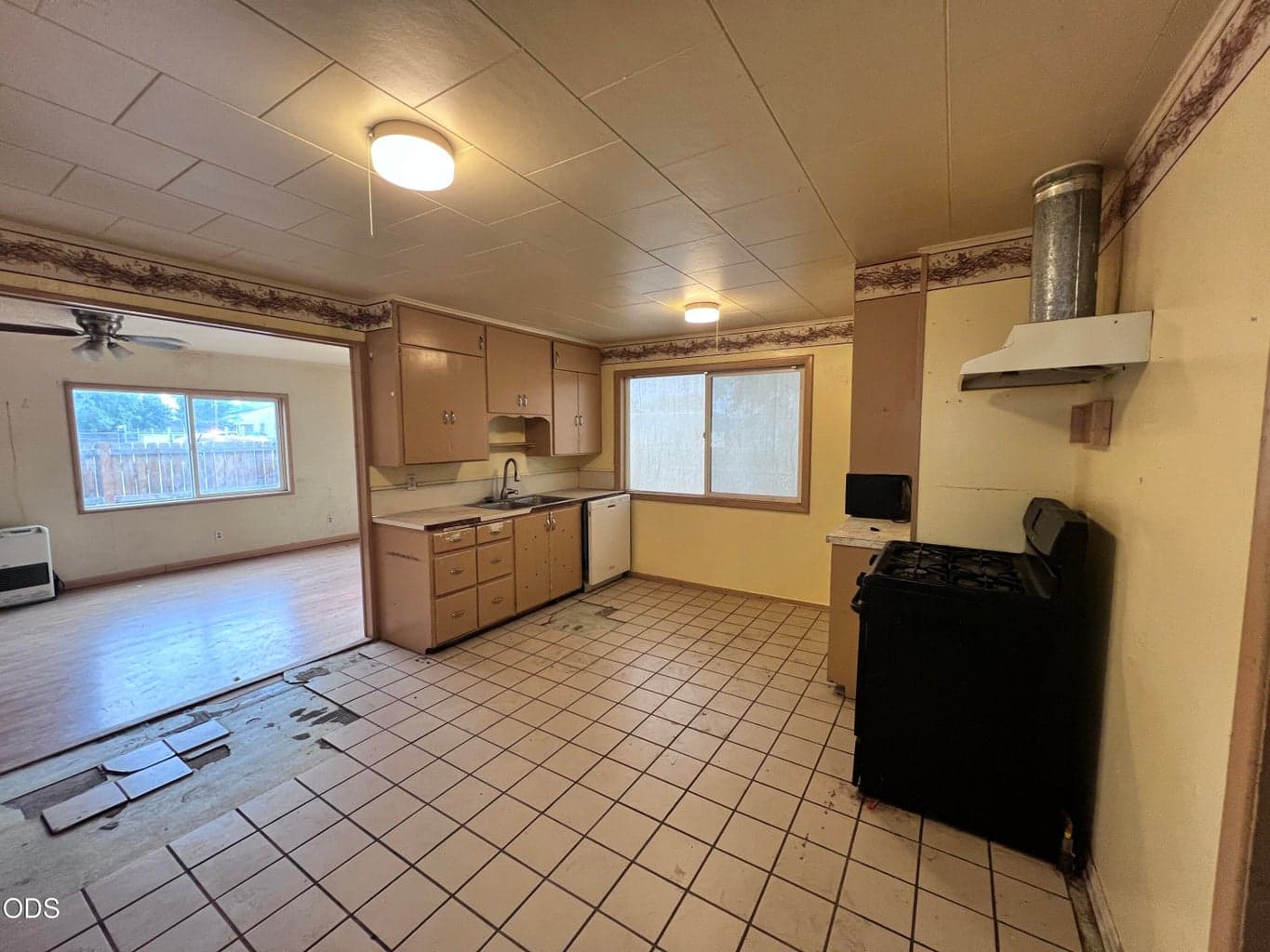 Large kitchen with gas appliances and tile flooring