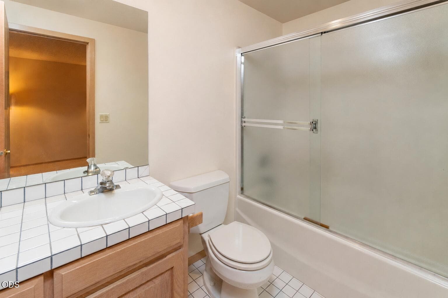 2nd primary ensuite with shower/tub combo. Tiled floor and counters.