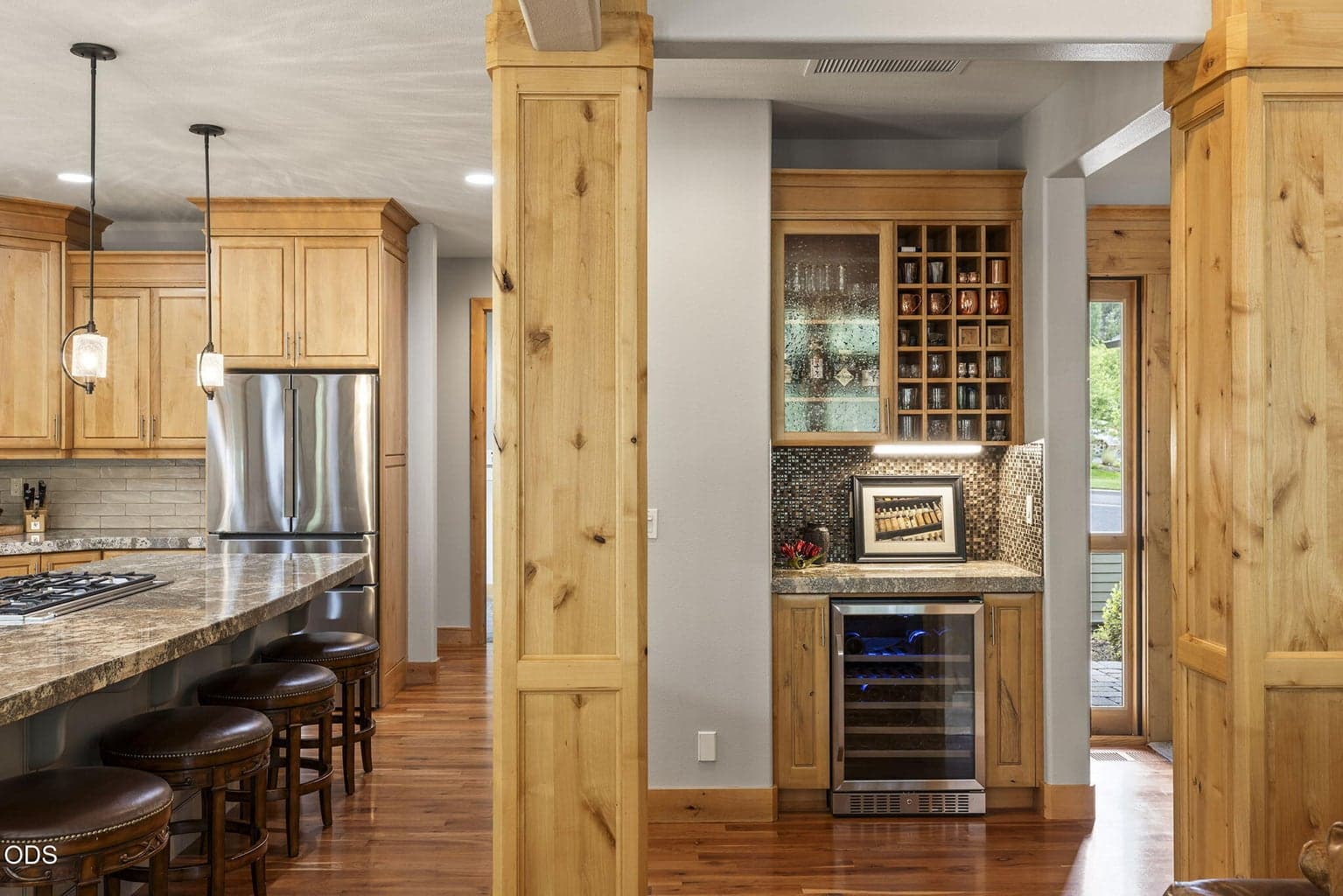 The dry bar and under-counter wine cooler are conveniently located adjacent to the kitchen.