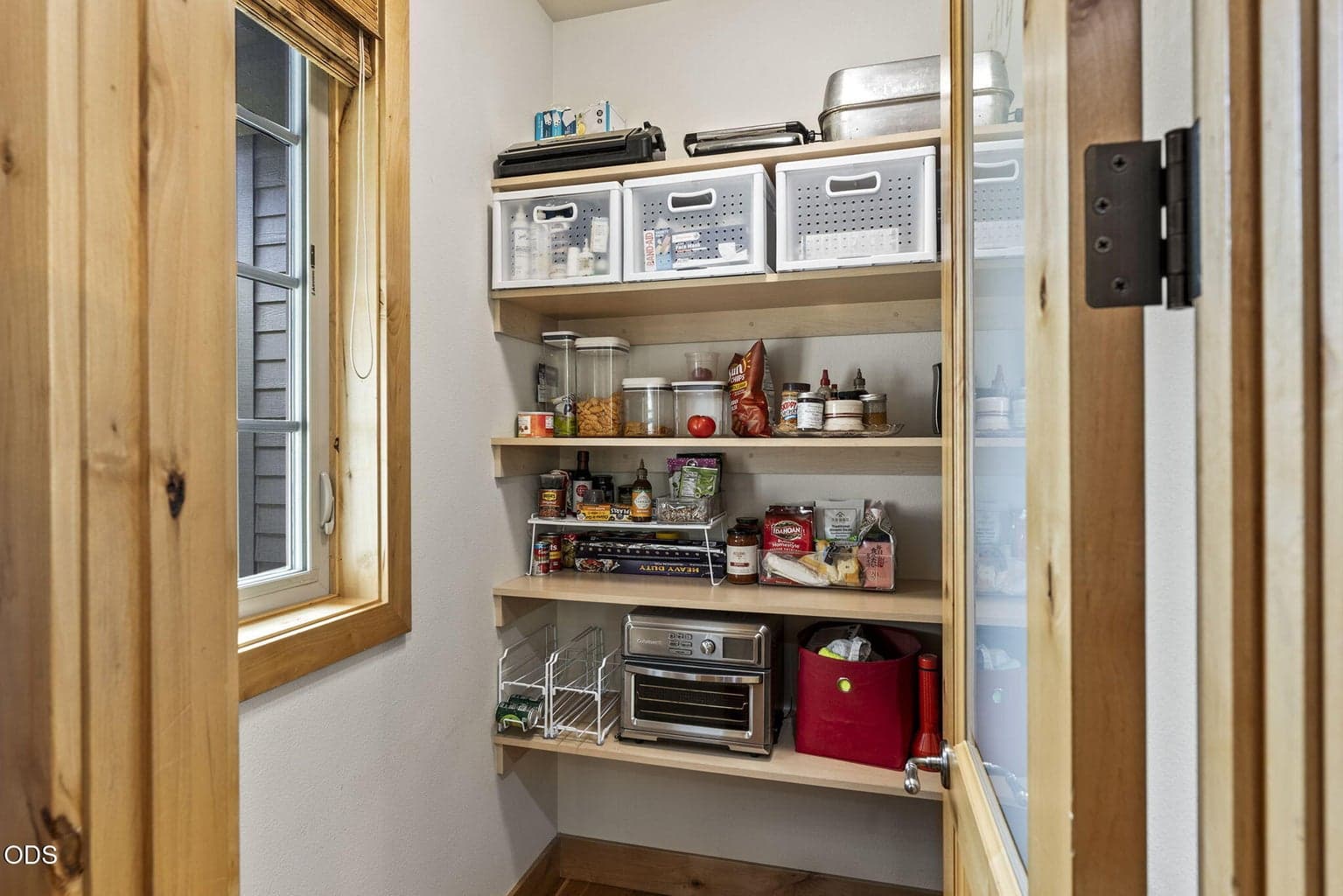 Pantry with 'L-shaped' wood shelving.
