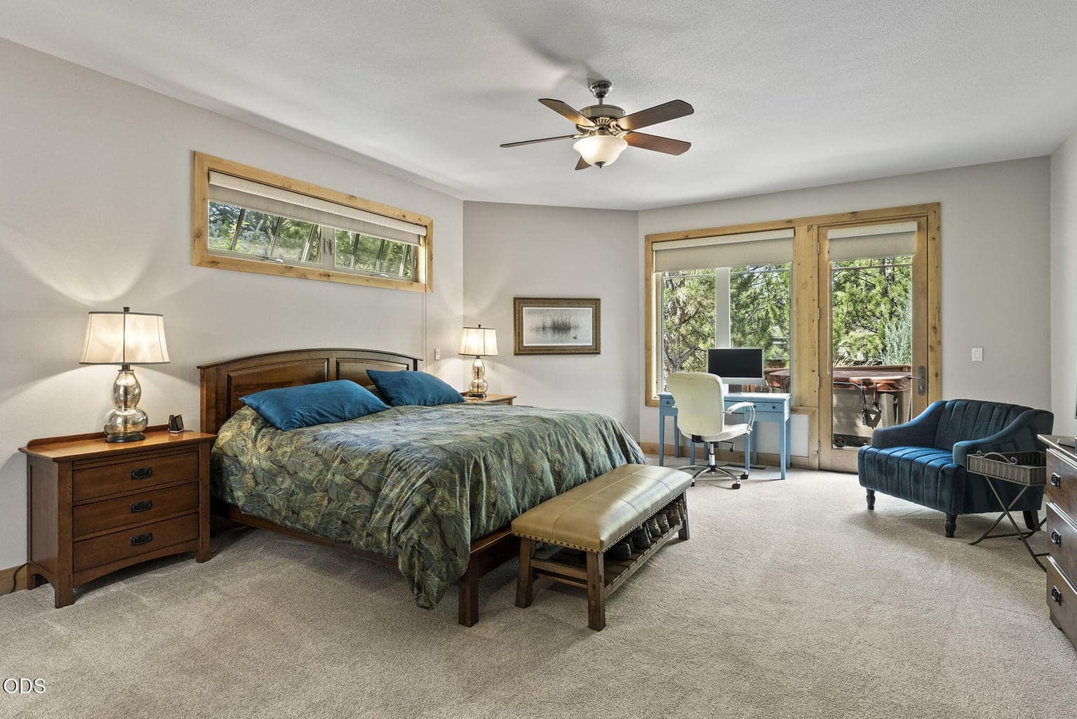 Expansive primary ensuite bedroom provides access to the hot tub.