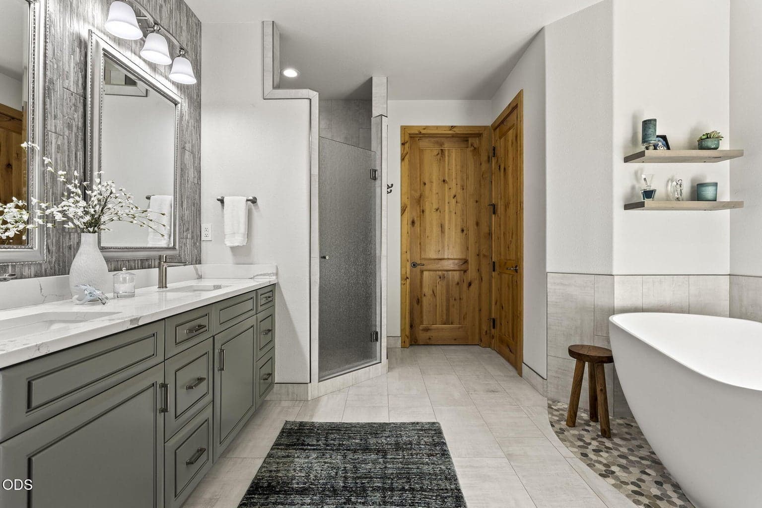 Original flooring updated with porcelain tile and custom pebble flooring.