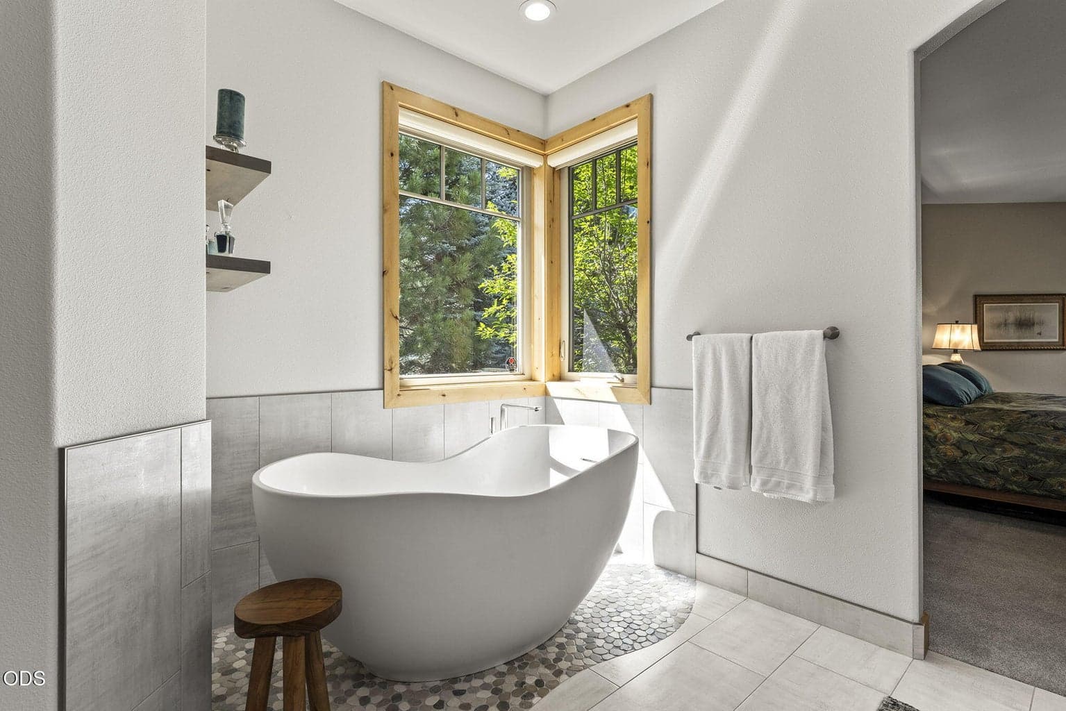 Free-standing soaking tub replaced a built-in corner bathtub.
