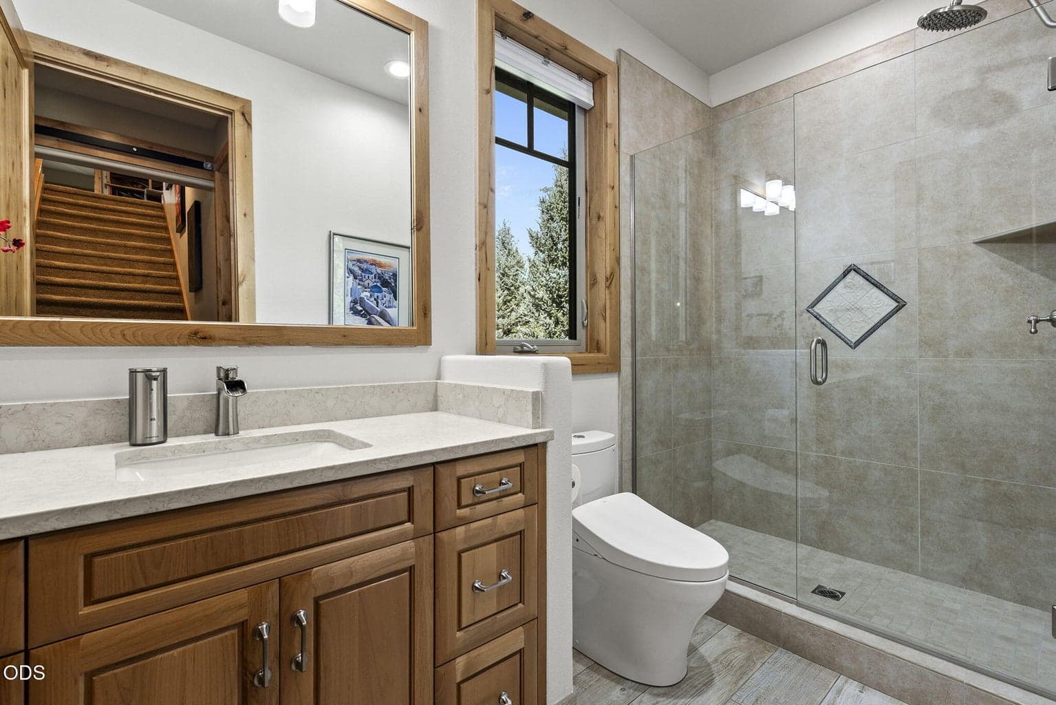 Fiberglass tub/shower combination replaced with porcelain wall tile, sliding glass shower door, solid surface countertop and a Toto Washlet.
