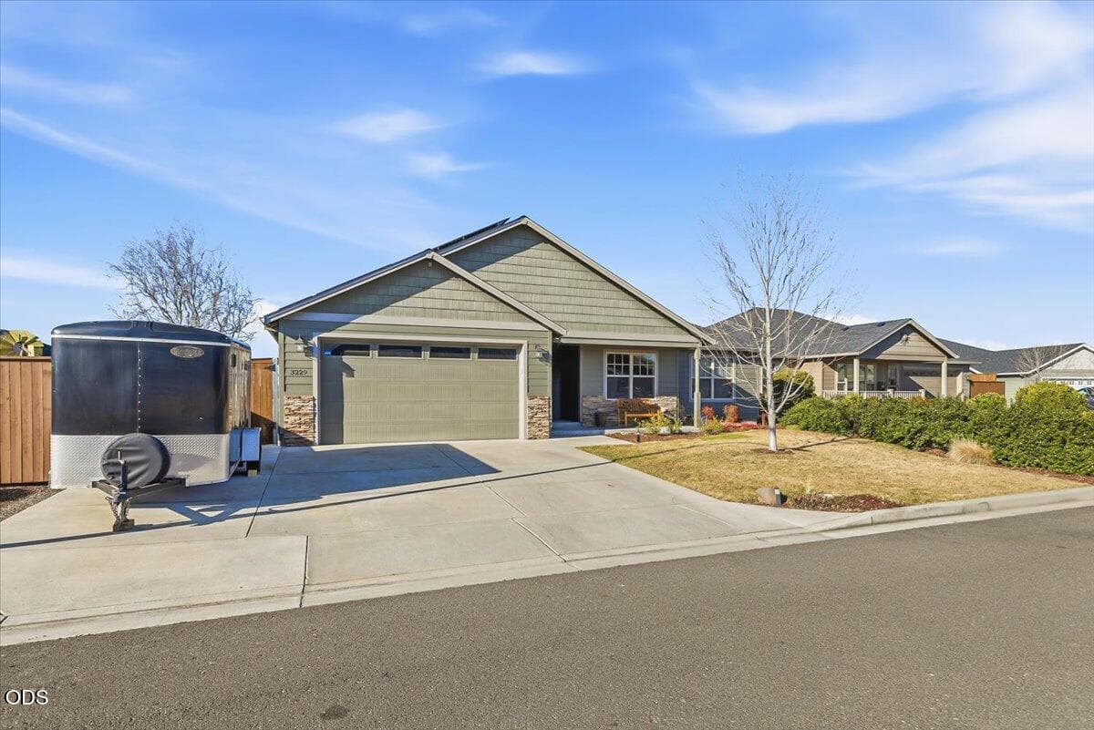 Front of home with paved RV parking in front.