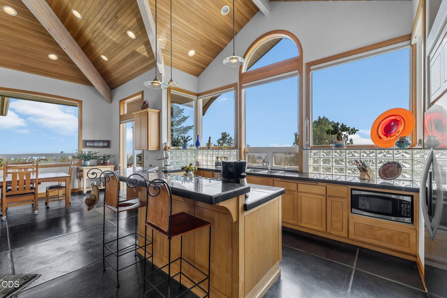 Enjoy this kitchen with the wall of windows that is bright and light, with Eastern Mountain views