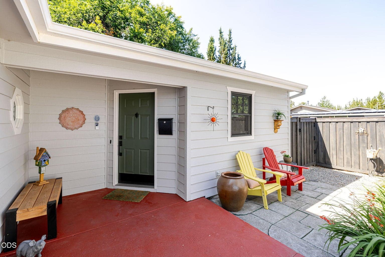 This welcoming entryway offers cover for inclement days and a cozy offset courtyard for conversations or quiet relaxation.