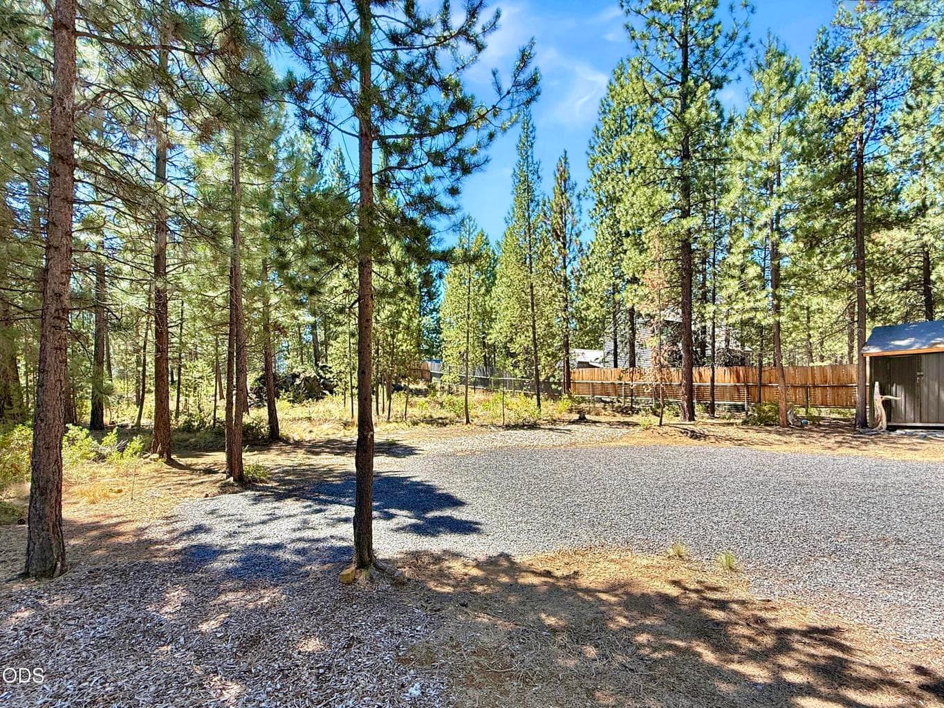 Cleared driveway and parking area, ready for building.