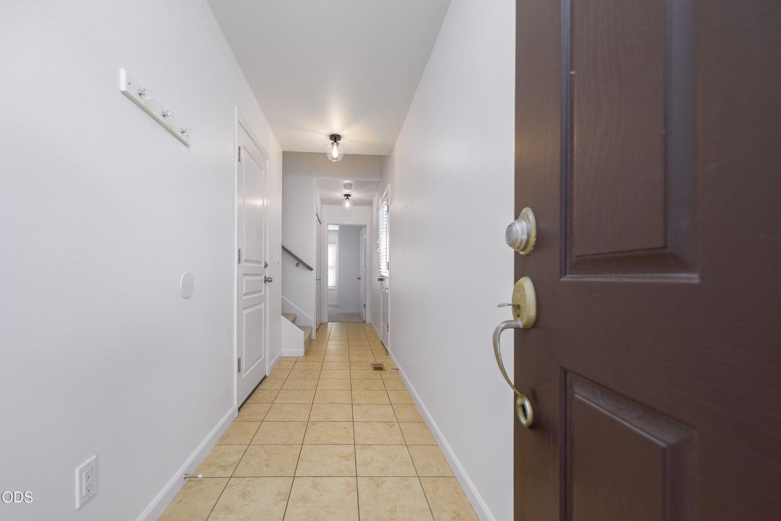 Entry leads to door in from the garage and another door to the fenced backyard, as well as the laundry area and entry level ensuite bedroom.