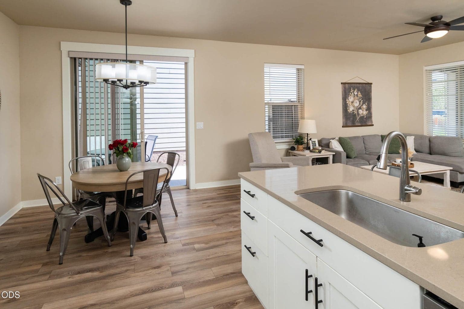 Light and bright home features solid surface counter tops, engineered wood-look flooring, all stainless appliances, and private patio just outside the sliding glass door.