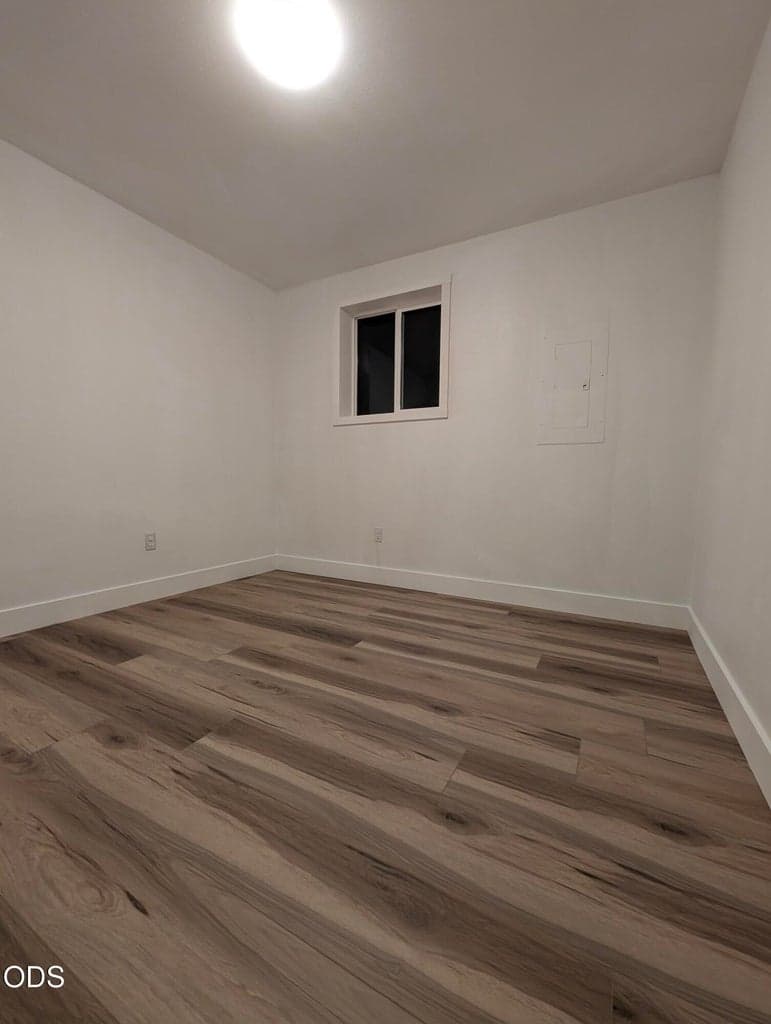 Flexible bonus room with updated flooring and neutral finishes, ideal for an office, hobby space, guest area, or additional storage.