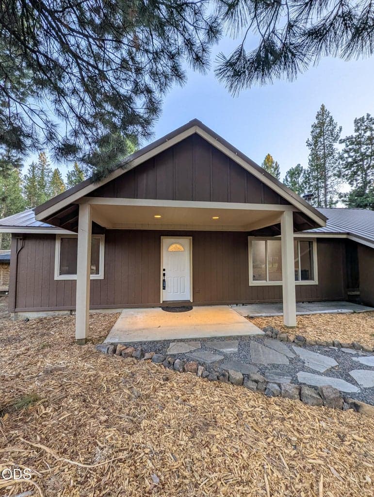 Covered front entry with a warm wood-accent exterior and easy access to the main living area.