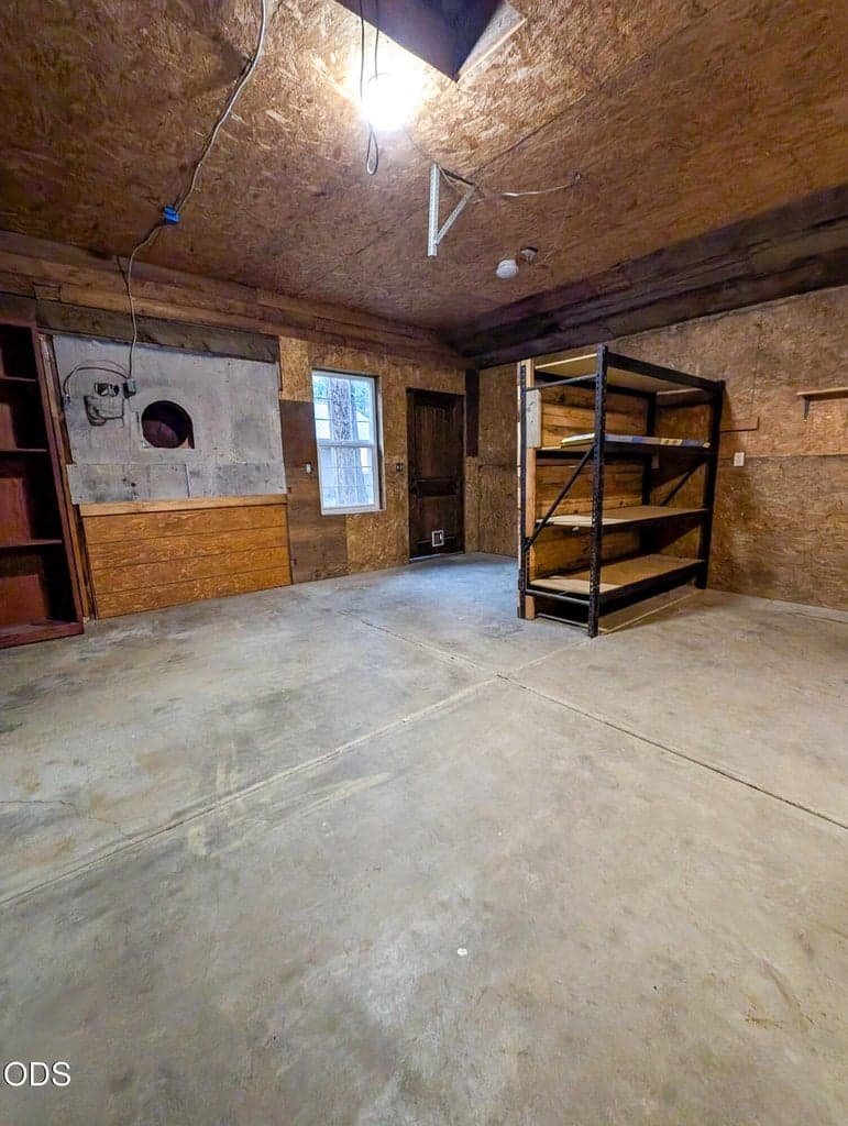 Interior of detached shop with concrete flooring, workbench space, and room for tools, storage, or projects.