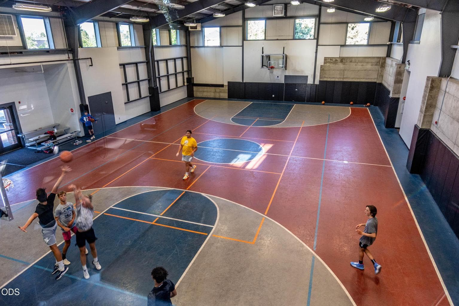 Windows around the top of the expansive sports court make this bright and pleasant.