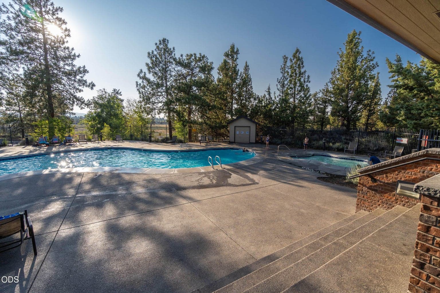 Plenty of space. The layout of the pool area with tables, chairs, and loungers.