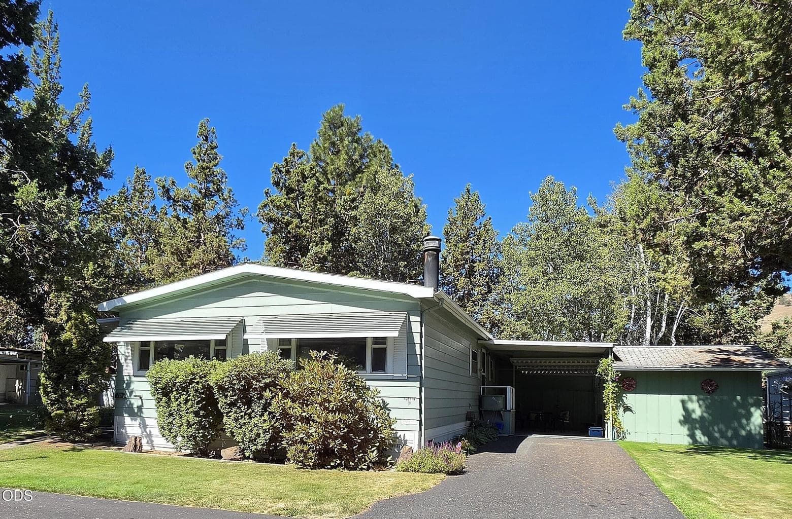 Home has attached carport and long driveway