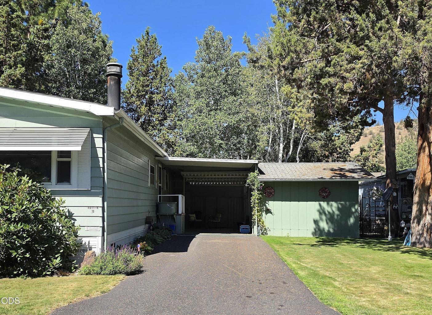 Long driveway in front of carport