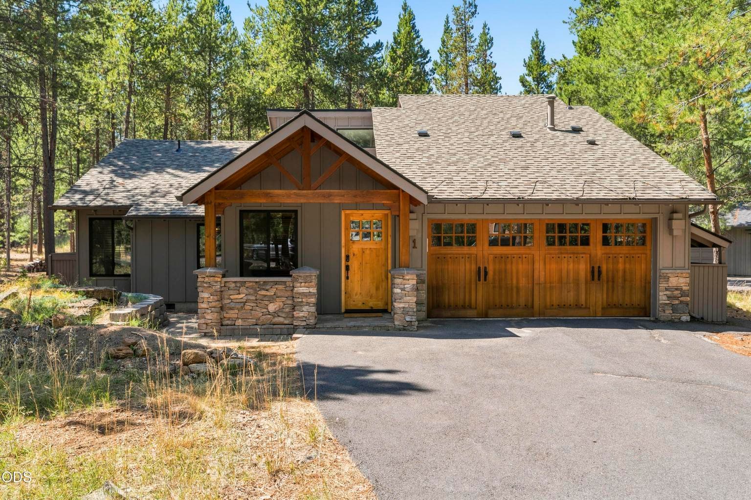 Classic Sunriver mountain architecture welcomes you with timber accents, stone columns, and an inviting covered front porch.
