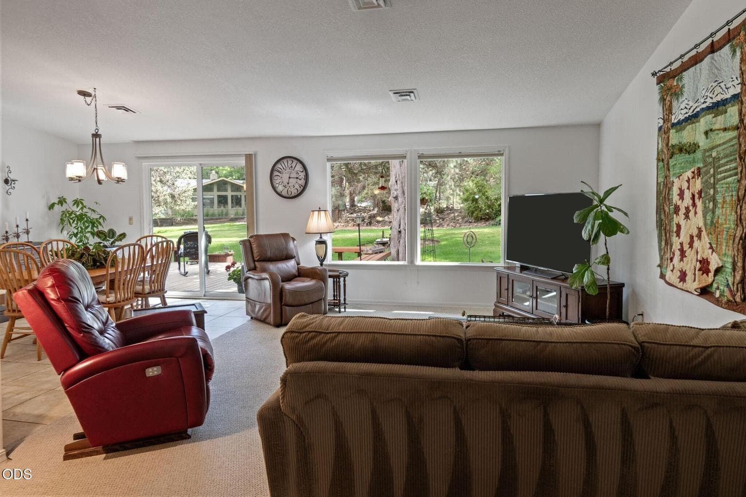 Large great room is light and bright with vaulted ceiling