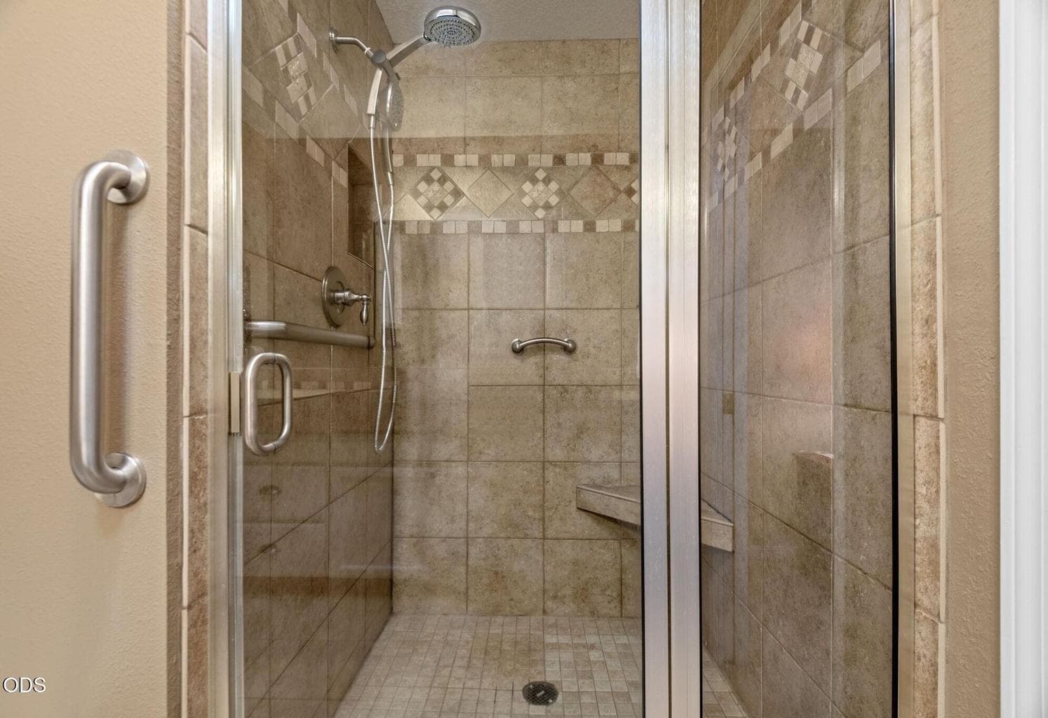 Beautiful tiled walk-in shower in primary bathroom