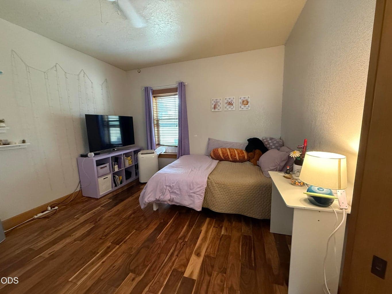 Has wood floors and ceiling fan.