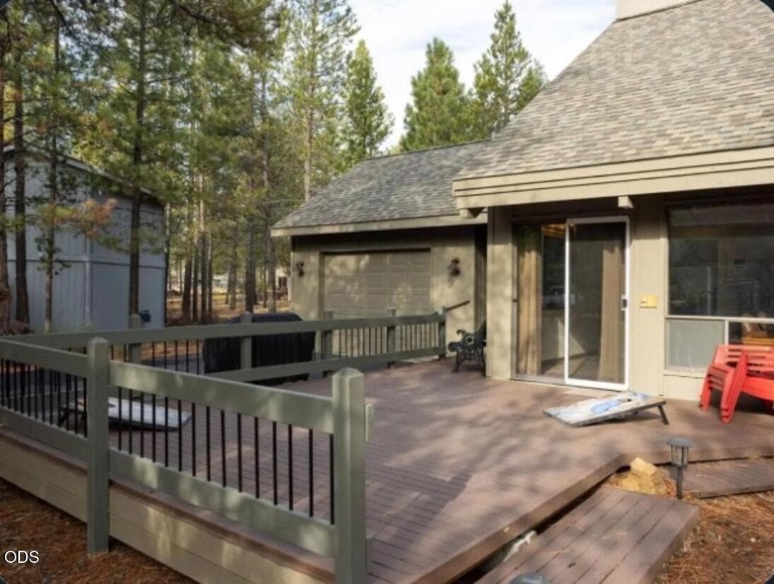 Welcoming front patio and deck framed by mature pines, offering a relaxed outdoor setting for morning coffee, dining, or gathering after a day of Sunriver recreation.