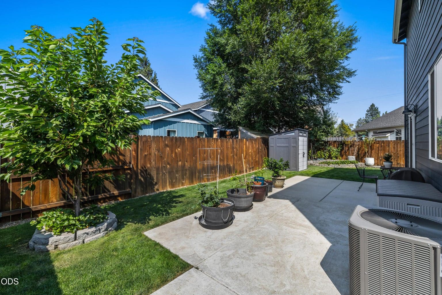 Fenced backyard with concrete patio.