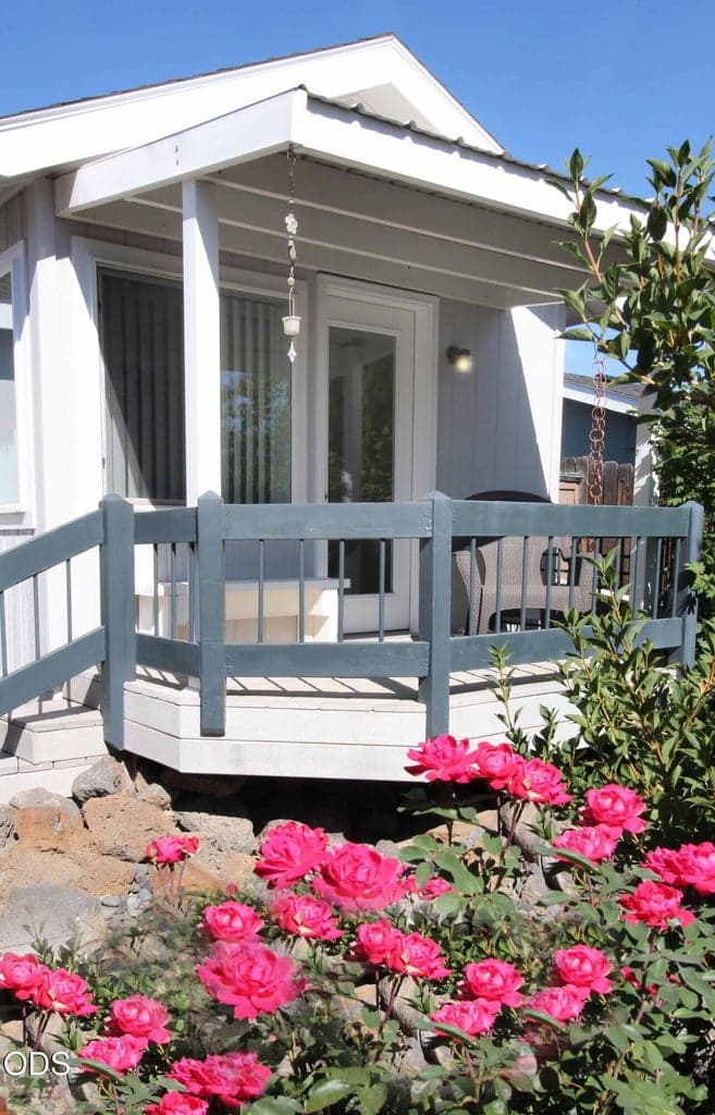 Photo 2 of the private covered porch off the Hobby/Office Room. And another of the many Rose Bushes.