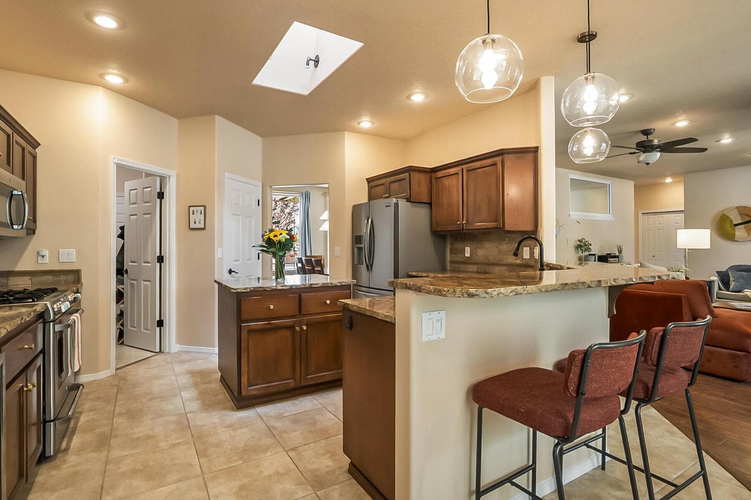 Spacious Kitchen with Island, Bar Seating, & Skylight