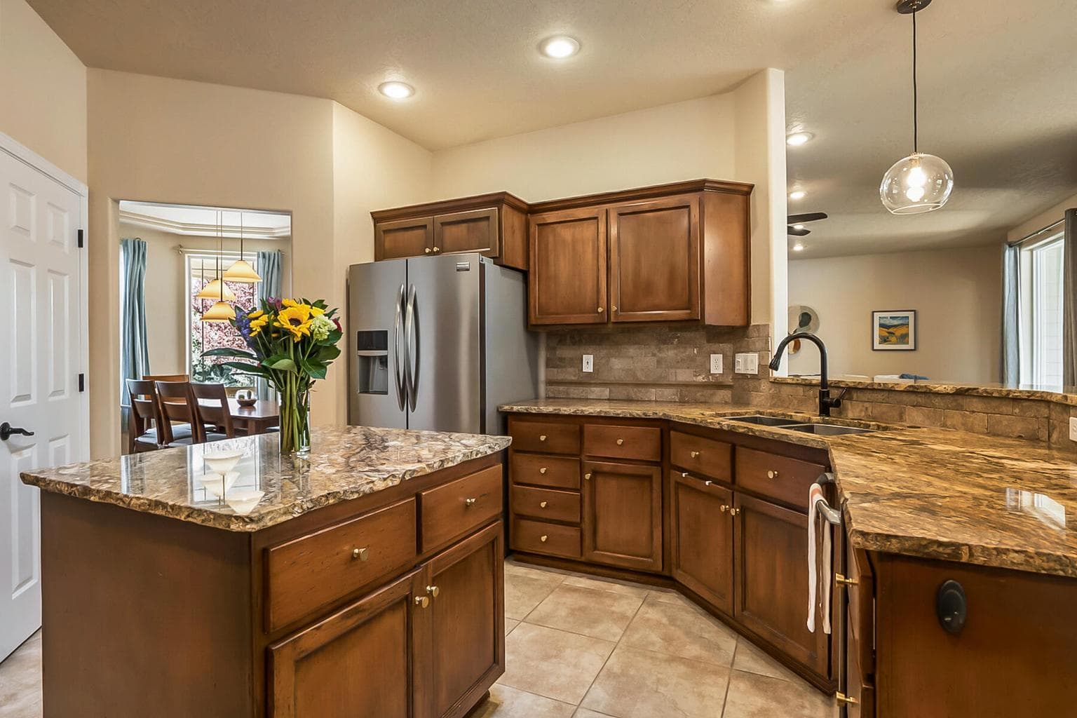 Spacious Kitchen with Island, Bar Seating, & Skylight