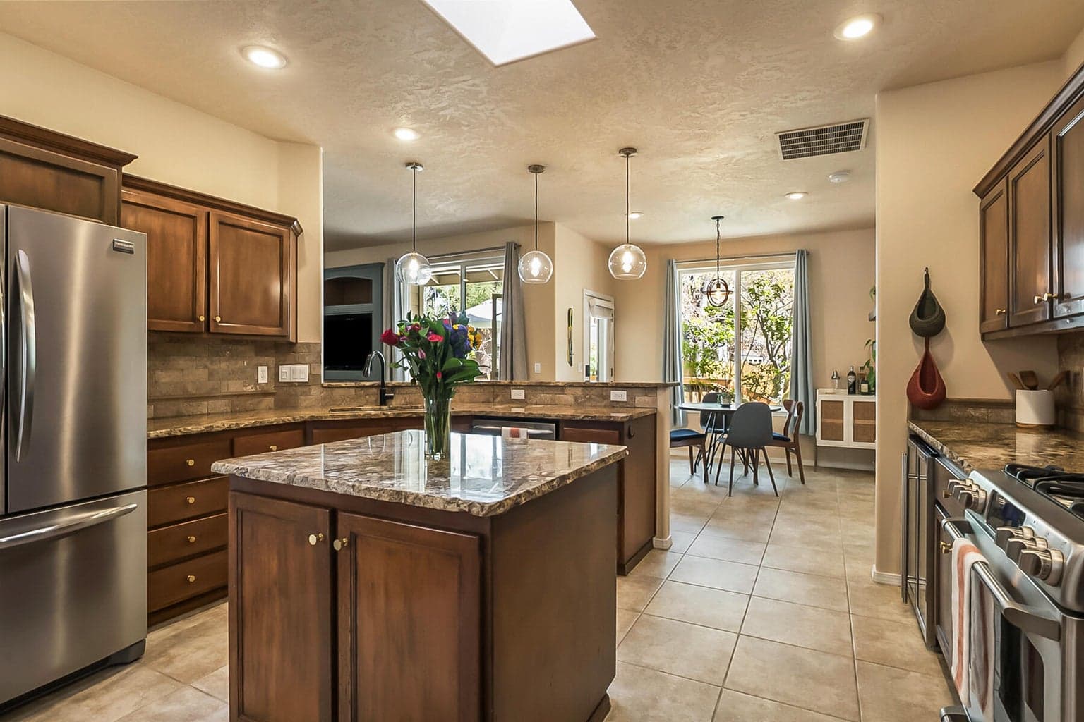 Spacious Kitchen with Island, Bar Seating, & Skylight