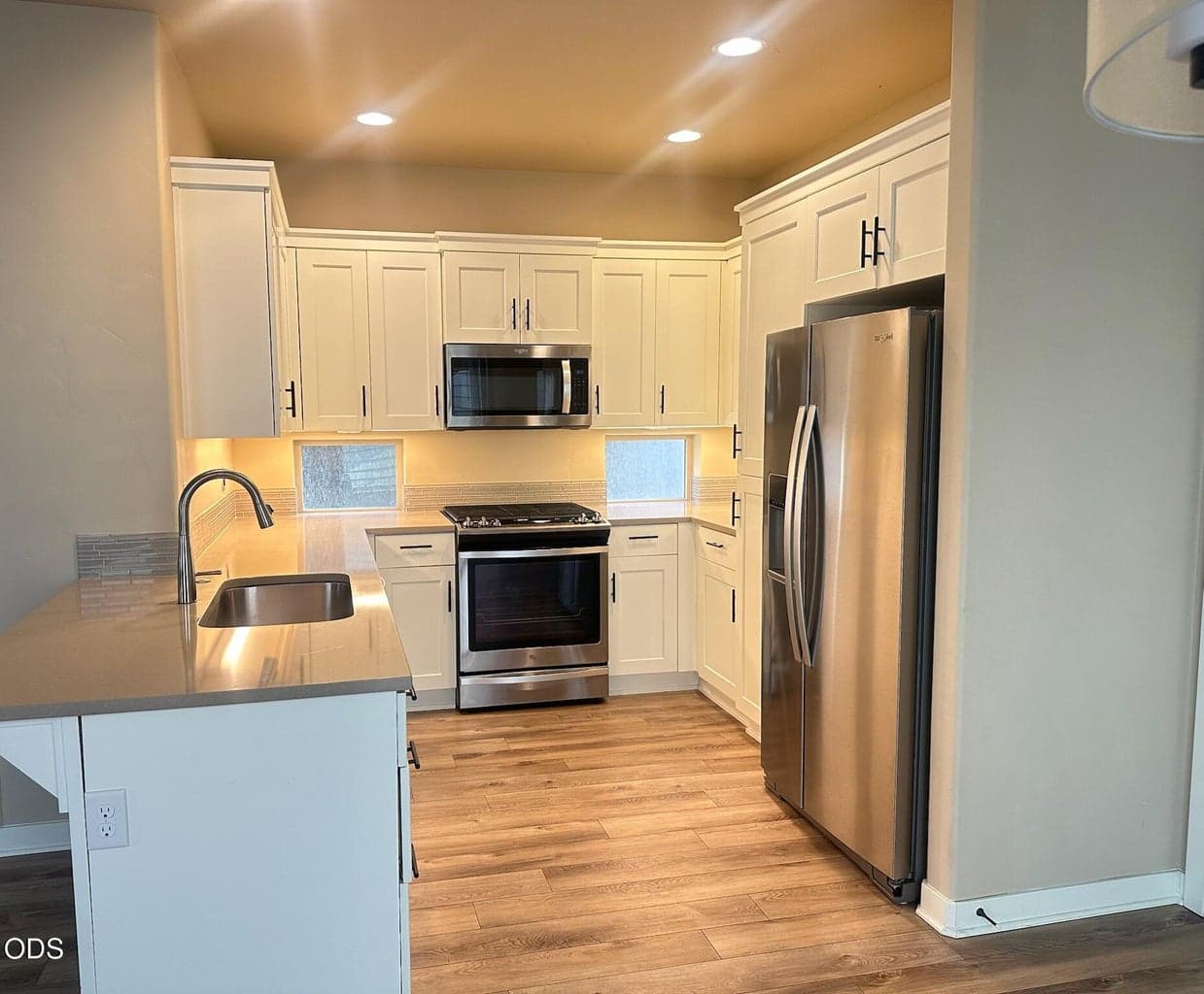 Well-planned kitchen, quality cabinetry, solid-surface counter tops, under-cabinet windows and lighting. Breakfast bar on the left, pantry on the right (not shown).