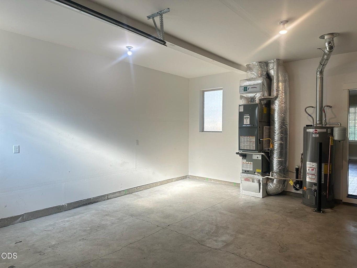 Large double garage also has this additional area for workshop, boat, or sports equipment. There are windows on both ends making this well-lit for working or hobbies.