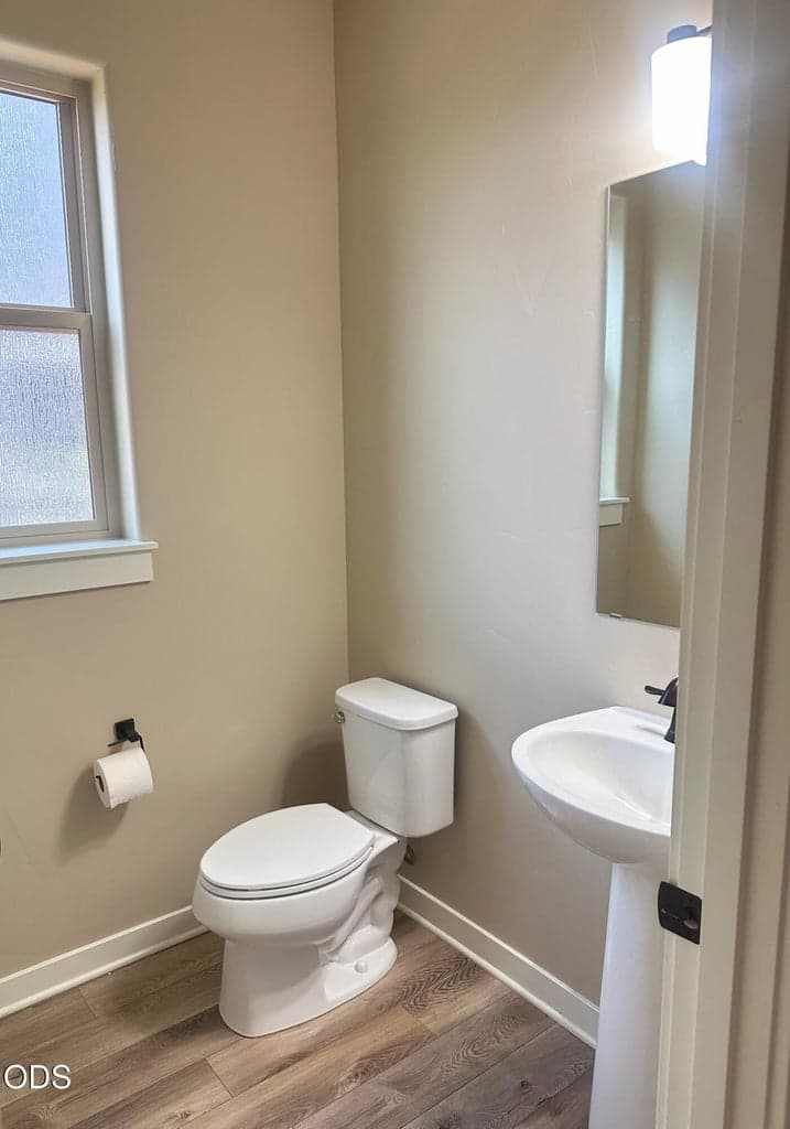 Powder room just off the entry and adjacent to the separate office on main level. Spacious including a window, also great for guests.