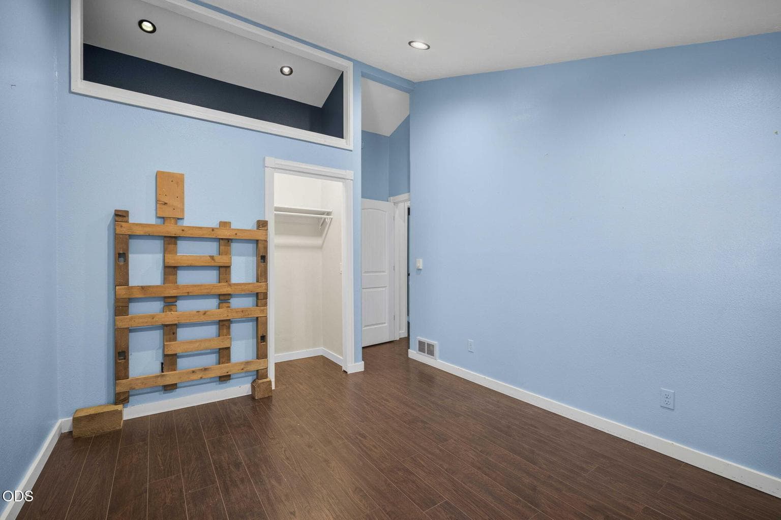 This bedroom has a loft area for storage or a cool reading nook