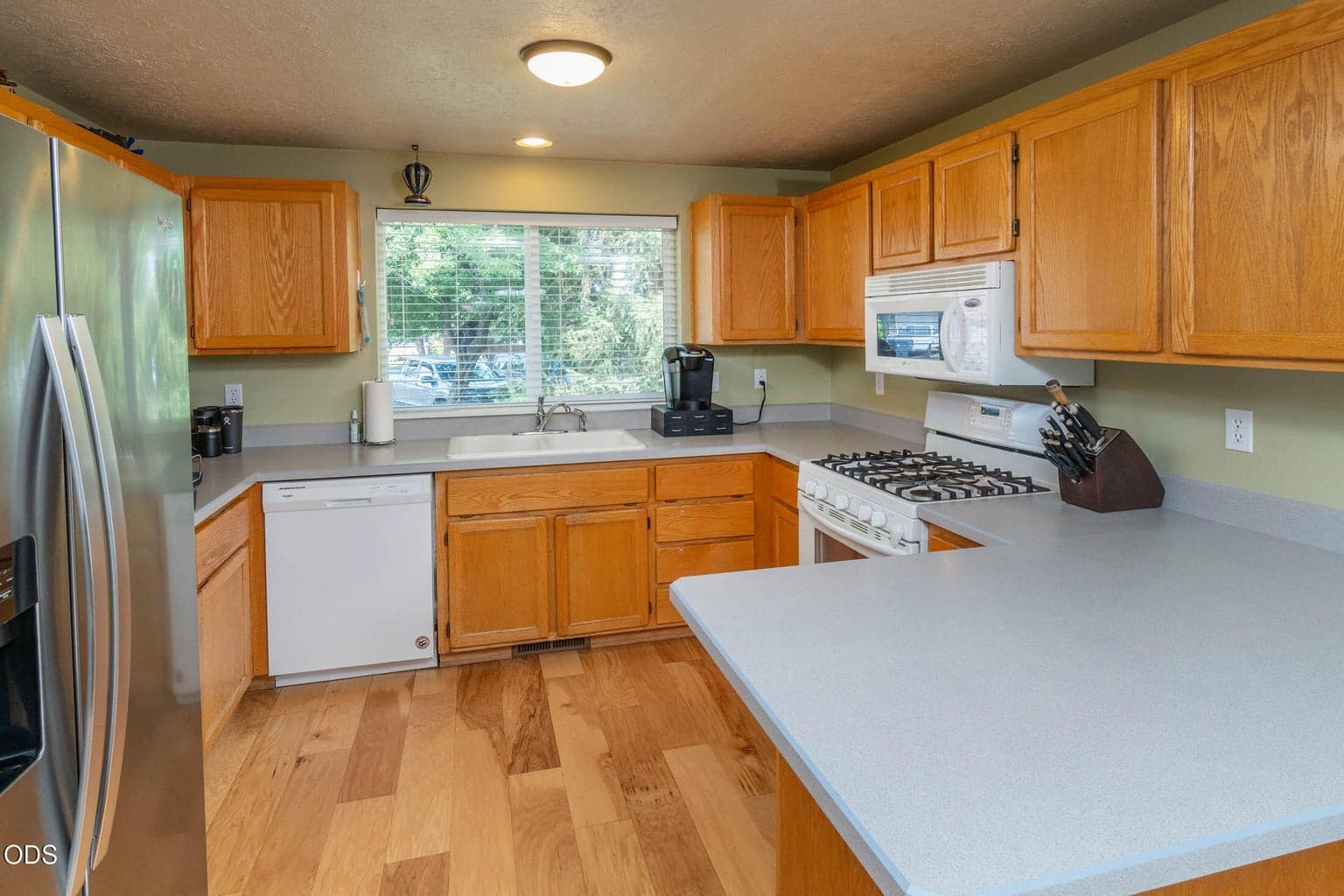 Spacious kitchen overlooks the front yard, has plenty of cabinetry and counter space including the breakfast bar. Quality white and stainless appliances are ideal.