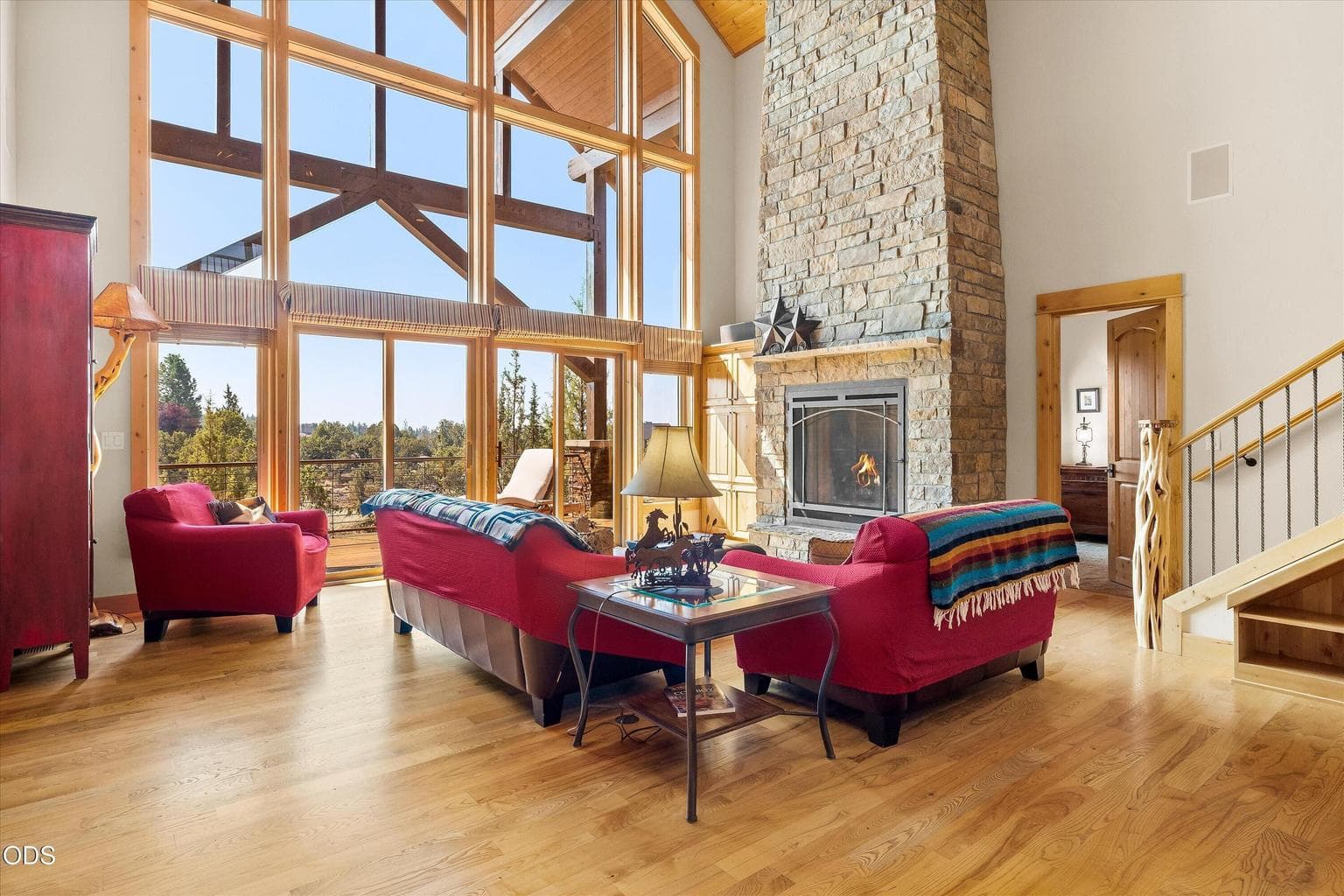 Vaulted ceilings, statement windows, and stone fireplace complete the stately and inviting Great Room