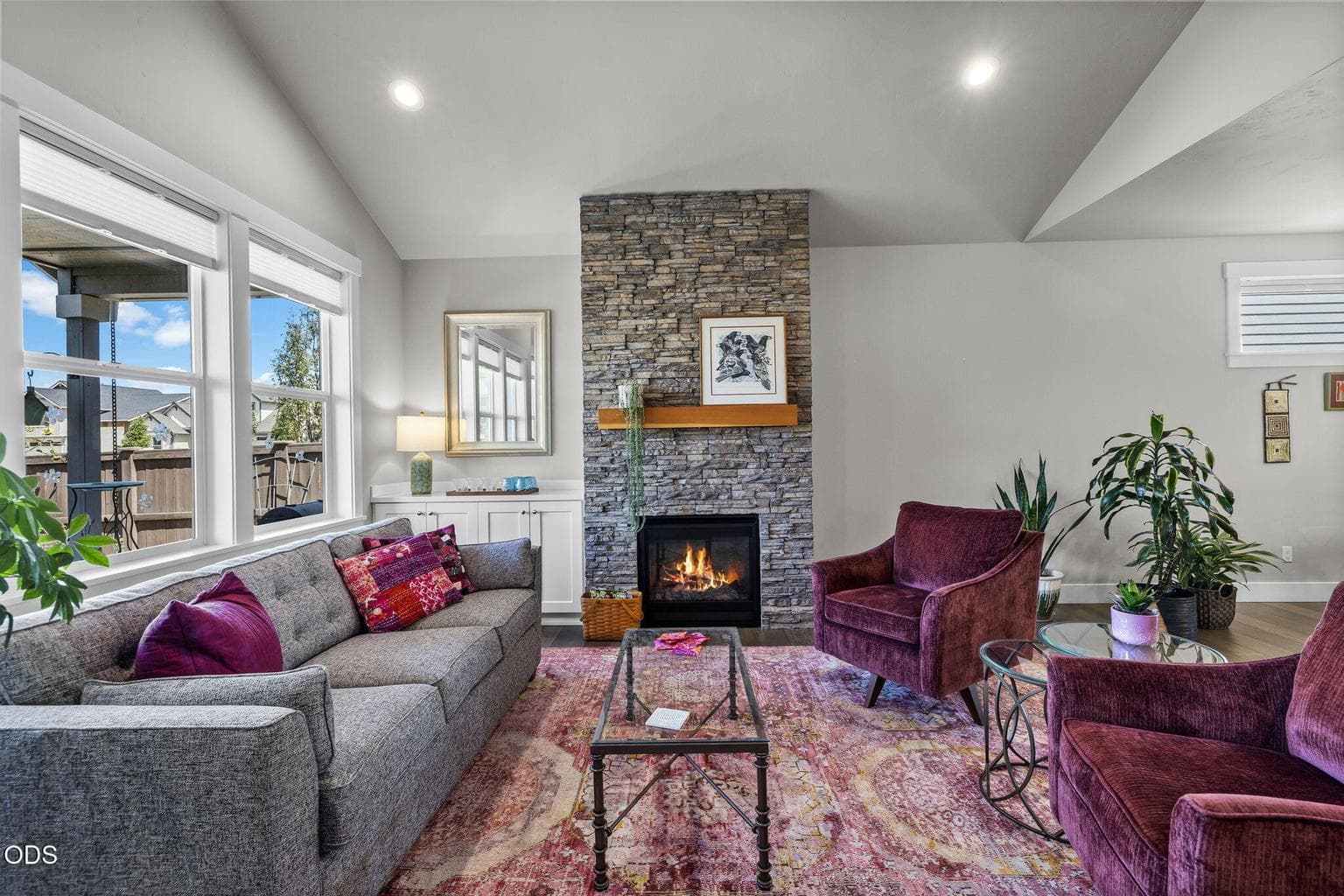 Floor to ceiling flagstone gas fireplace with sideboard storage