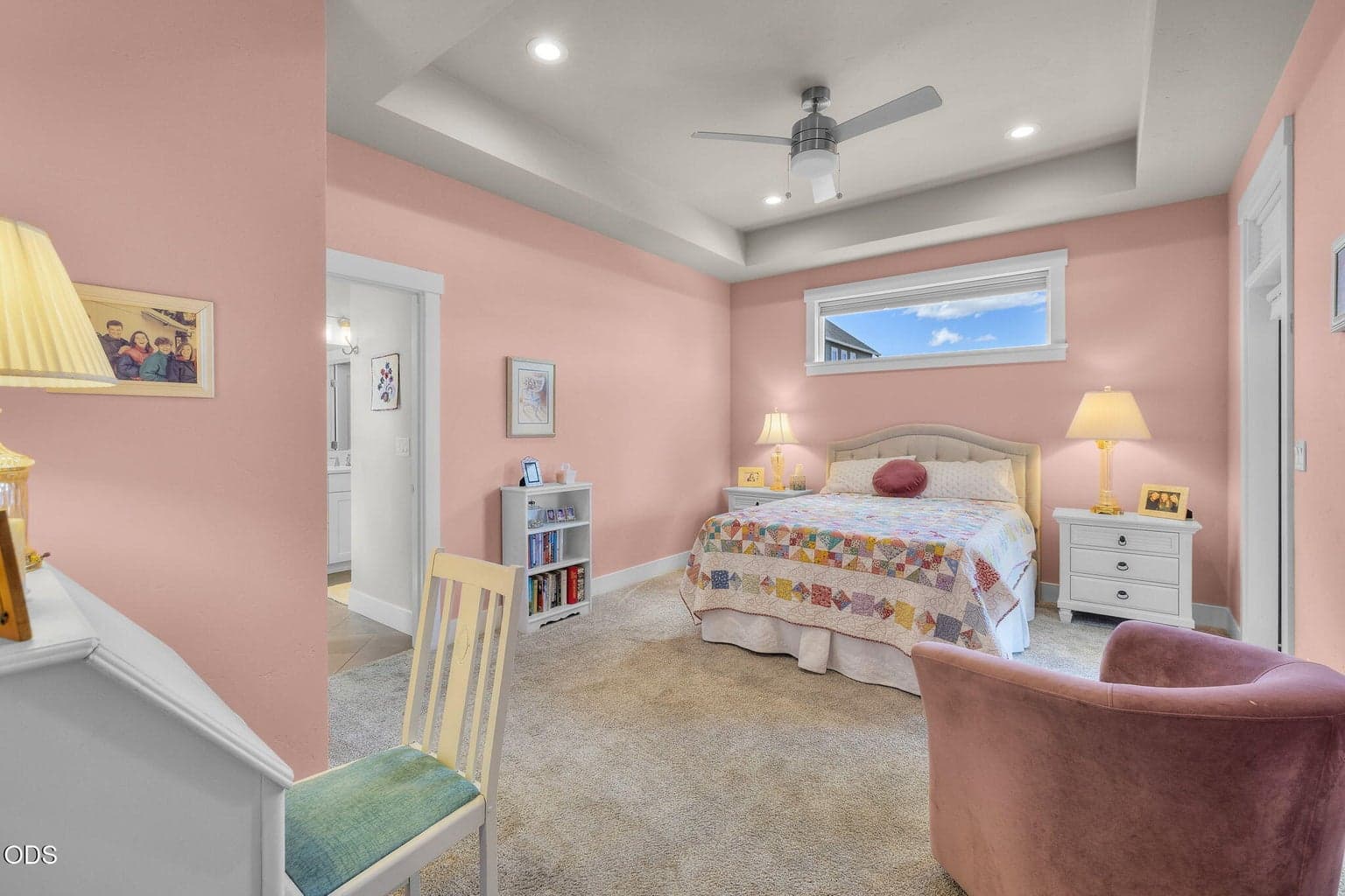 Primary suite with coved ceiling and ceiling fan