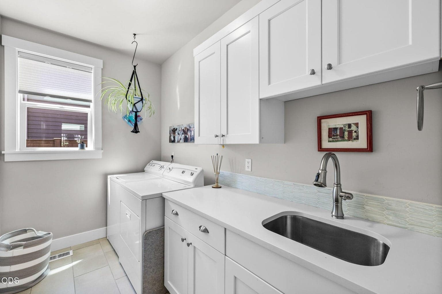 Laundry room with sink and storage