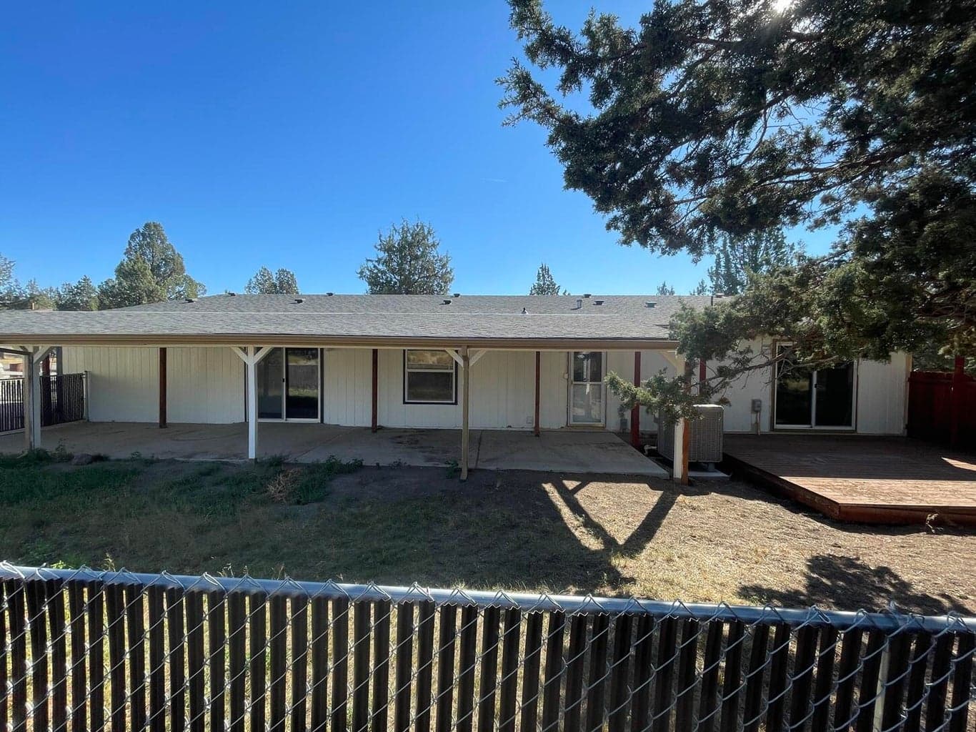 Back yard is fenced with access from the dining room, laundry room and primary bedroom's ensuite office/studio.