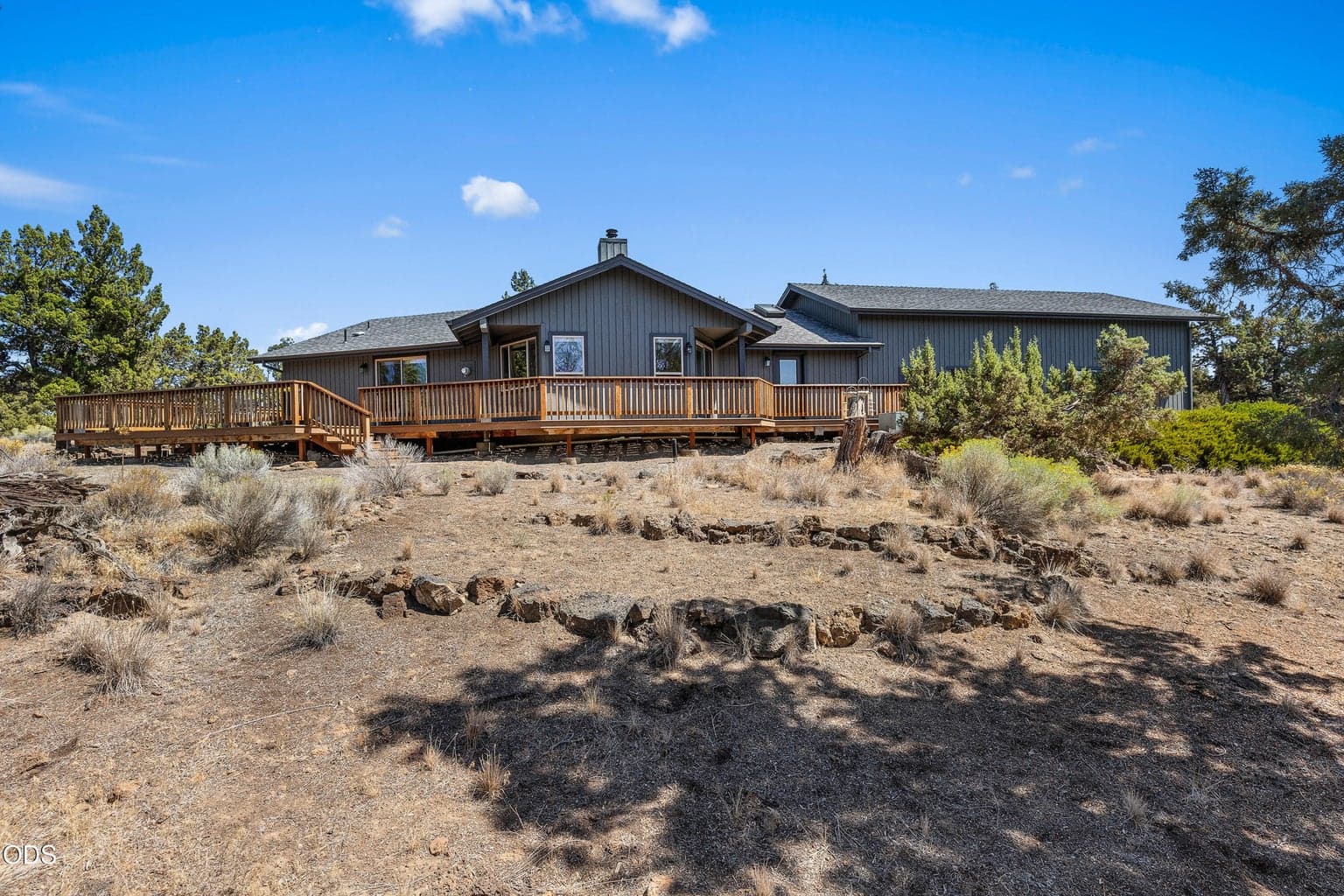 west side of the house sits on a rock ridge looking down over the property